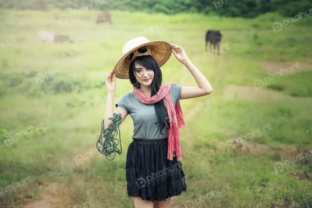 Free Premium Stock Photos A woman standing in a field and wearing a traditional Vietnamese hat and a colorful scarf with roof
