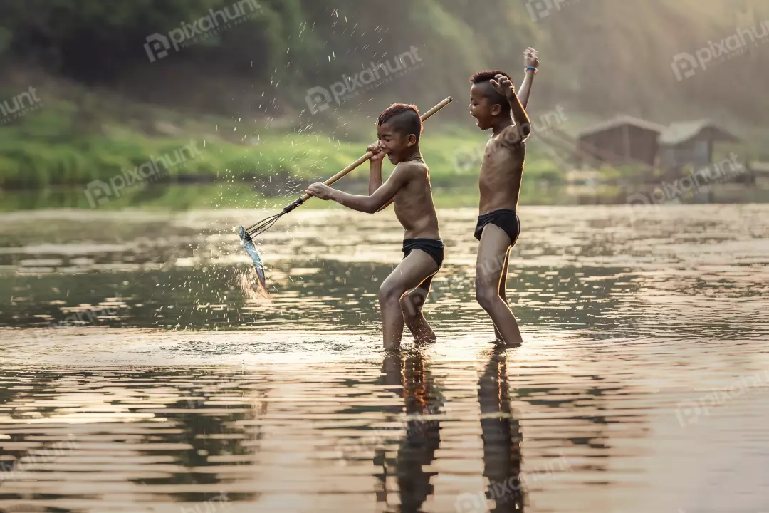 Free Premium Stock Photos Two children boys playing in a river and boys are both smiling and appear to be having a great time