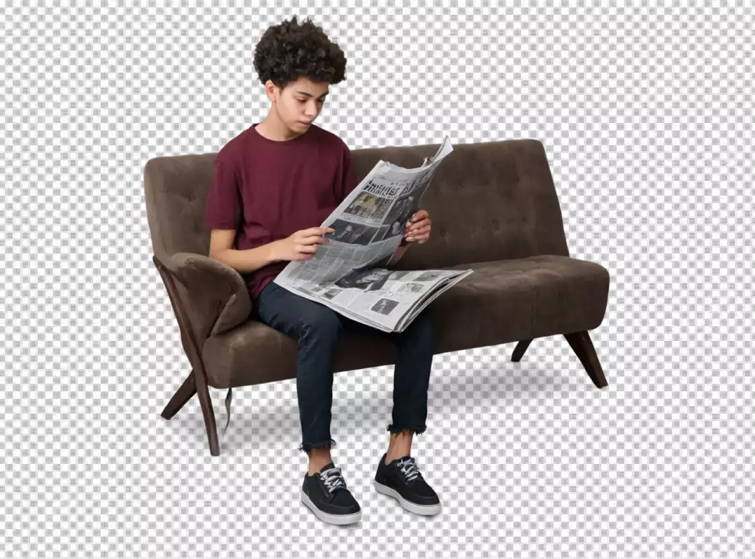 Young man intently reading newspaper on a comfortable brown sofa capturing a moment of focused engagement