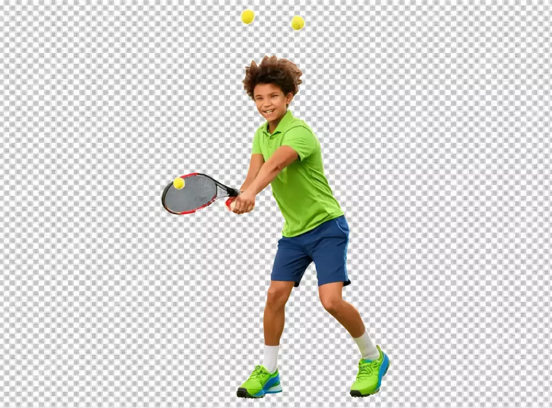 Energetic young boy hitting tennis ball with racket, smiling brightly on white background.