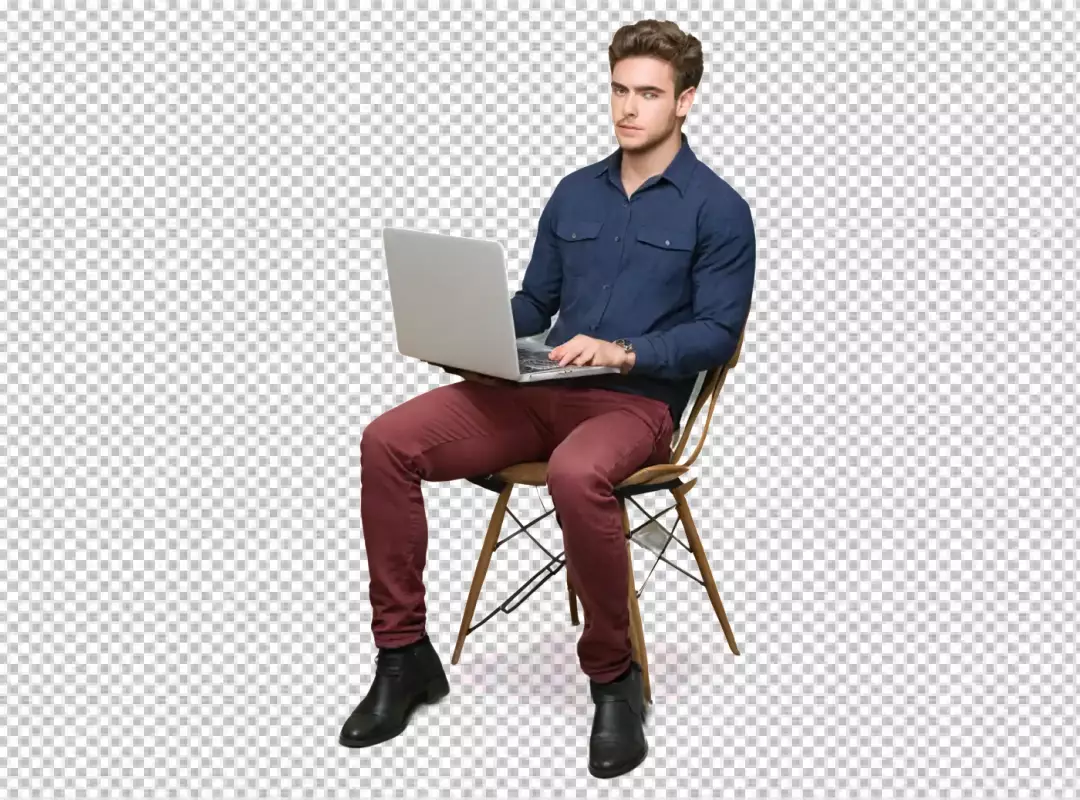Focused Young Professional Man Working on Laptop while Sitting on Modern Chair