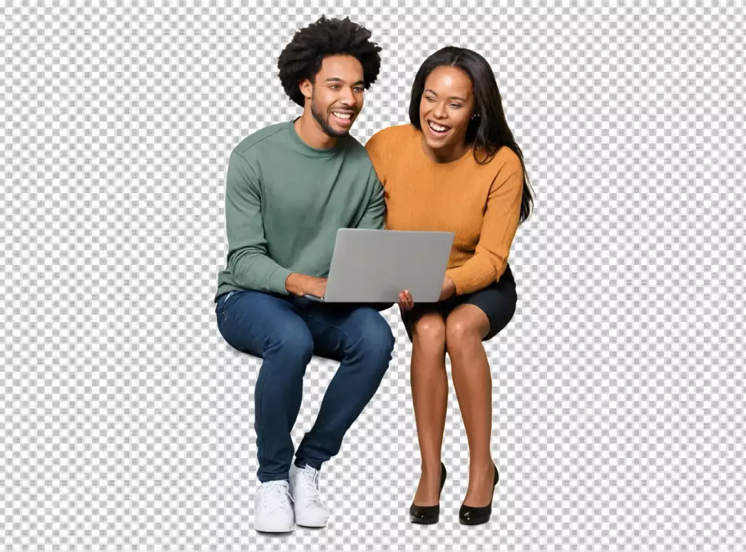 Happy young couple engaging with laptop enjoying online content together laughing