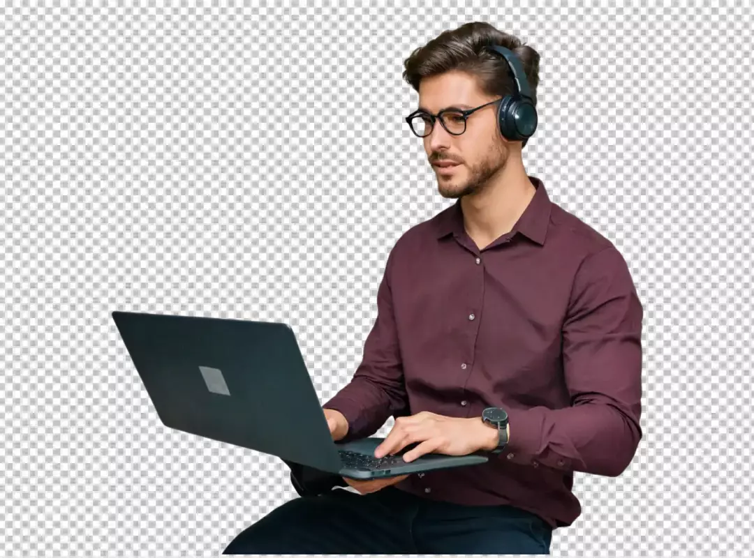 Focused Young Man with Headphones and Glasses Working on Laptop for Online Productivity