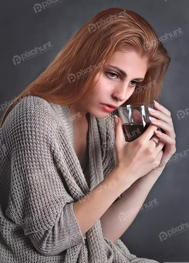Contemplative Redhead Woman in Knit Cardigan with Dark Beverage