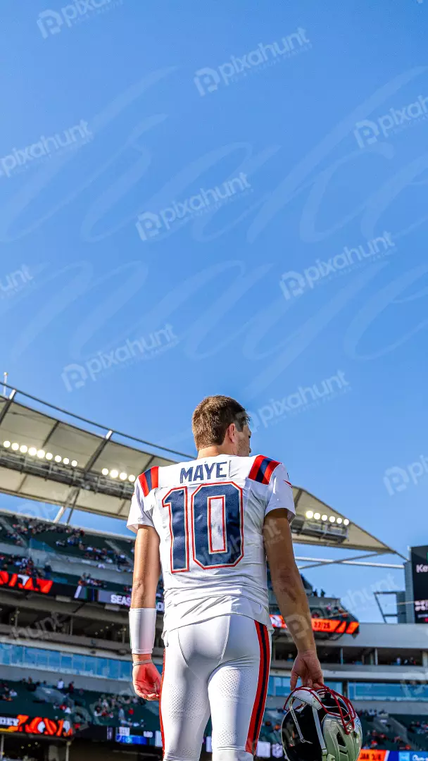 Football Player MAYE 10 on the Field Holding Helmet
