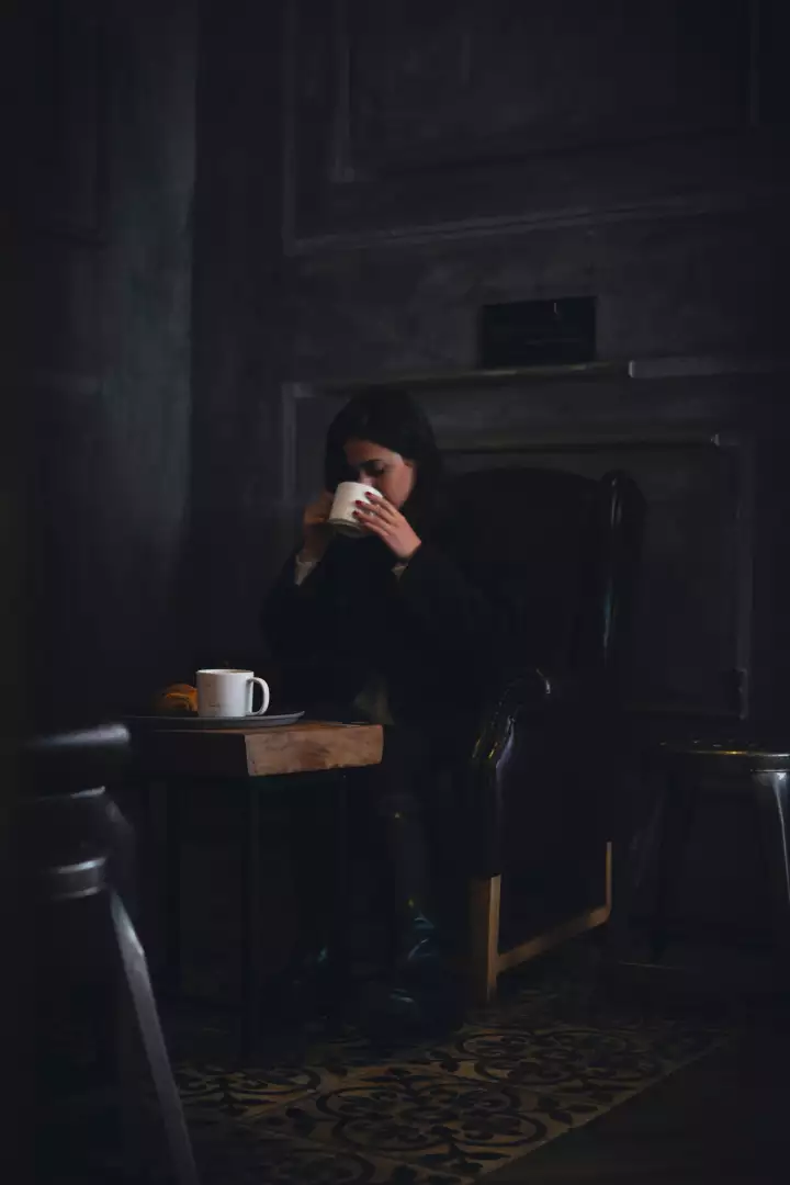 Free Premium Stock Photos Woman enjoying a cozy moment with coffee and croissant indoors