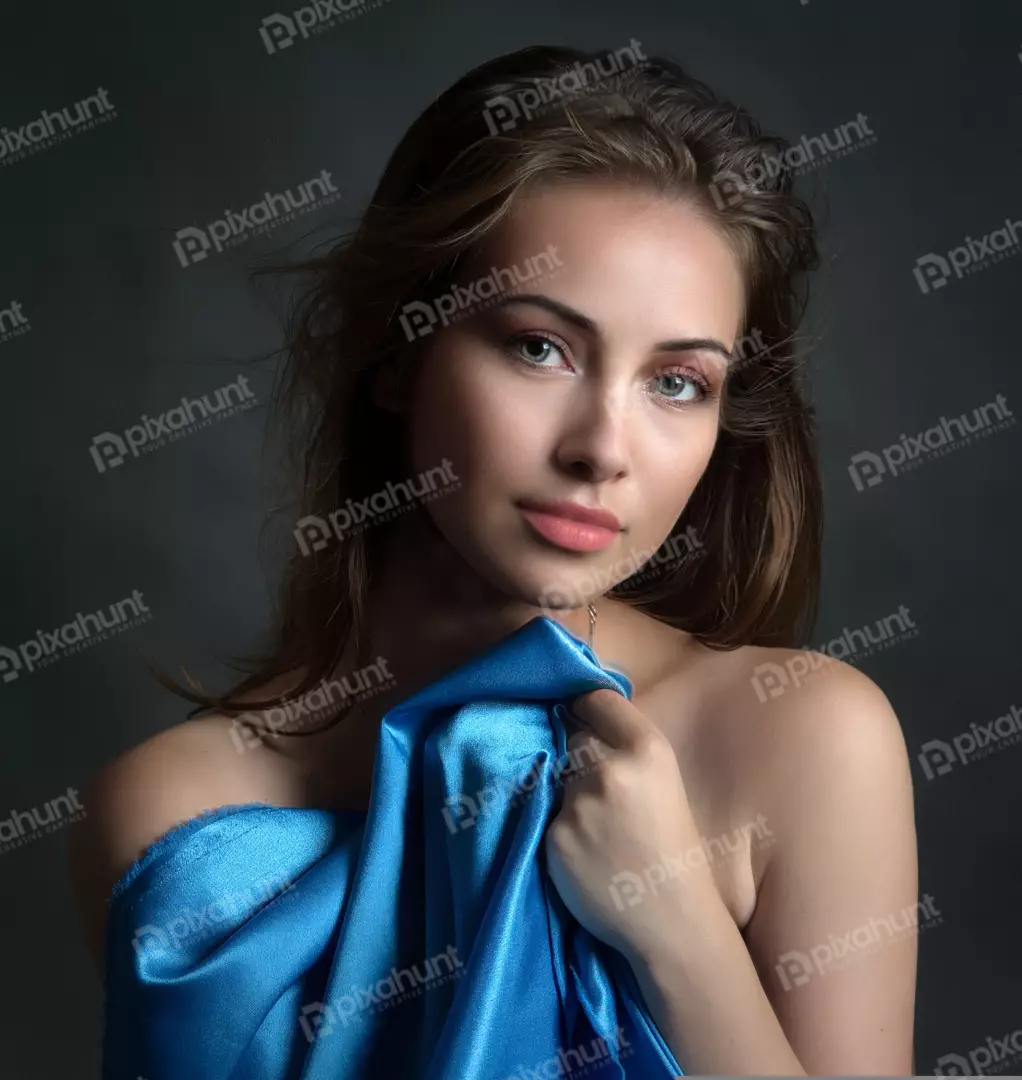 Elegant Woman Draped in Blue Satin Looking at Camera