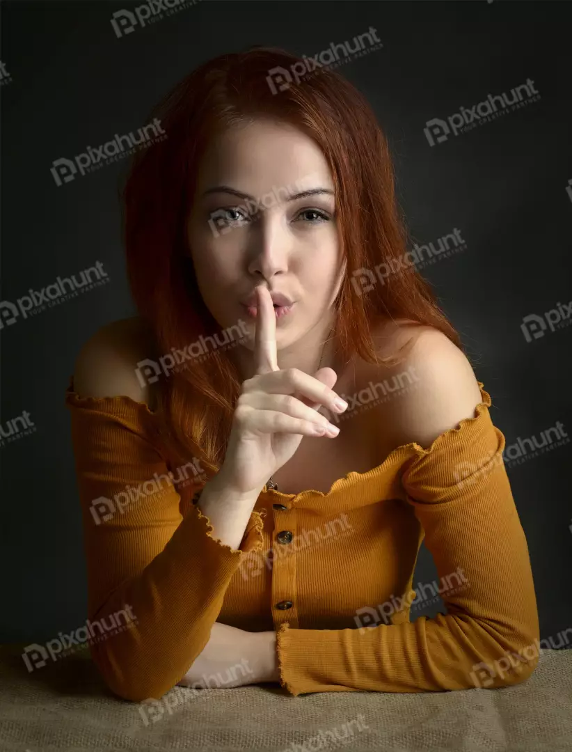 Redhead Woman Silencing with Finger on Lips Secretive Gesture