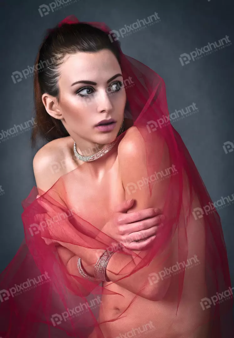 Elegant Woman Draped Red Sheer Fabric Diamond Jewelry Pensive Gaze