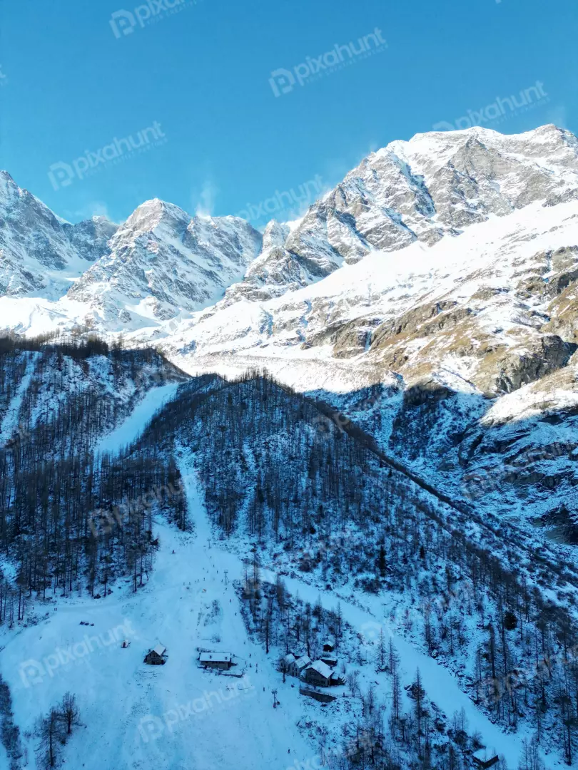 Free Premium Stock Photos Scenic ski resort village nestled among snow-covered mountains and trees