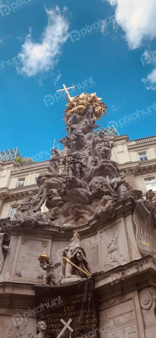 Free Premium Stock Photos Ornate Baroque Column with Golden Cross Against Blue Sky