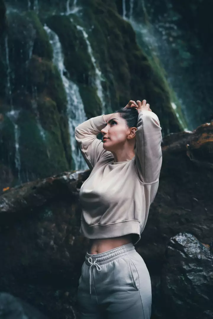 Free Premium Stock Photos Young Woman Enjoying Refreshing Waterfall in Natural Activewear Fashion