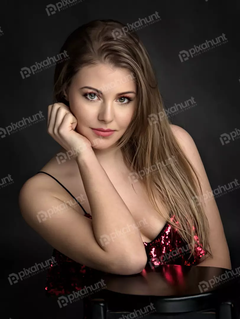 Confident Young Woman in Sparkling Red Sequin Top, Dark Background
