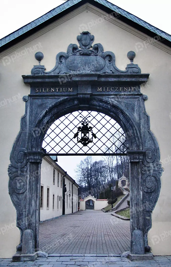 Grand Stone Archway with 'Silentium Milczenie' Inscription at Historic Monastery Entrance