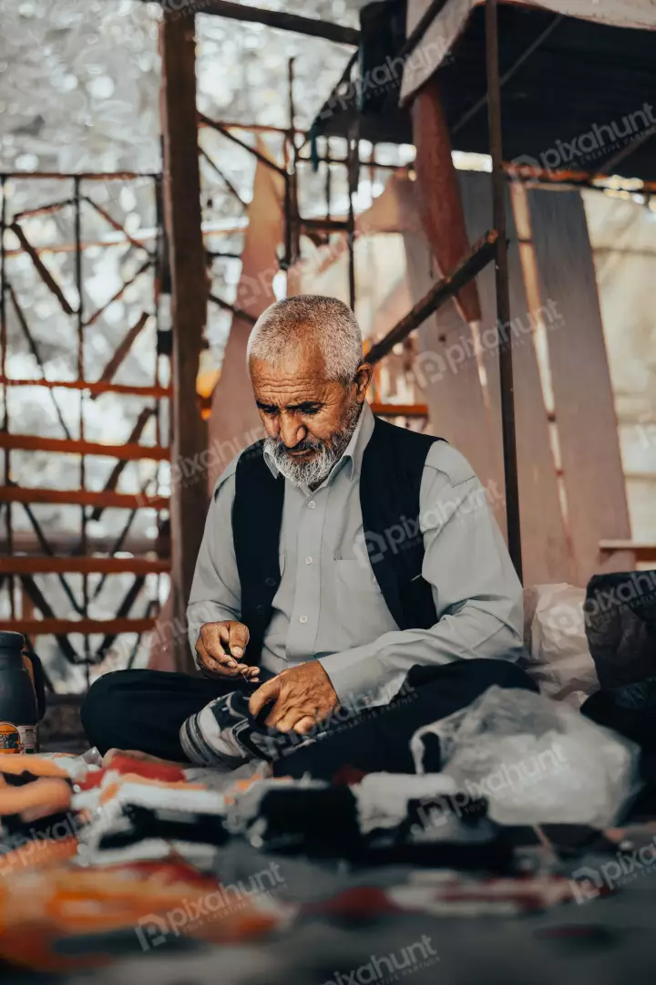 Free Premium Stock Photos Elderly Craftsman Focused on Detailed Handiwork