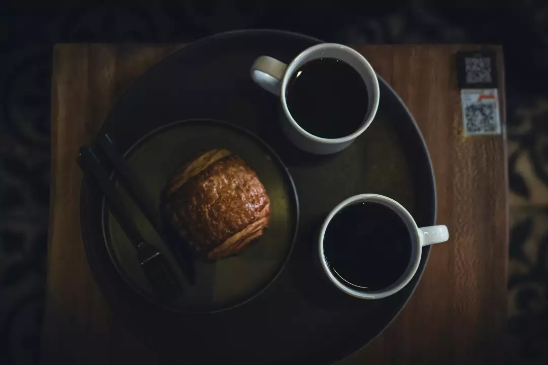 Free Premium Stock Photos Cozy coffee break with a pastry and two cups of coffee