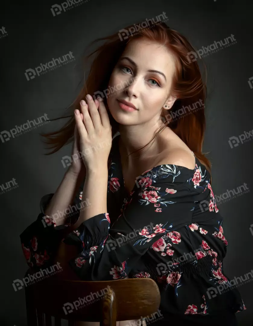 Young Woman with Red Hair in Floral Dress and Clasped Hands