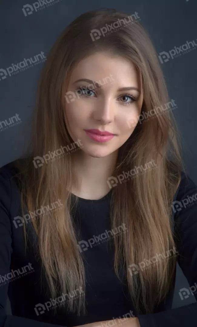 Beautiful Young Woman with Long Brown Hair and Pink Lipstick Looking at Camera