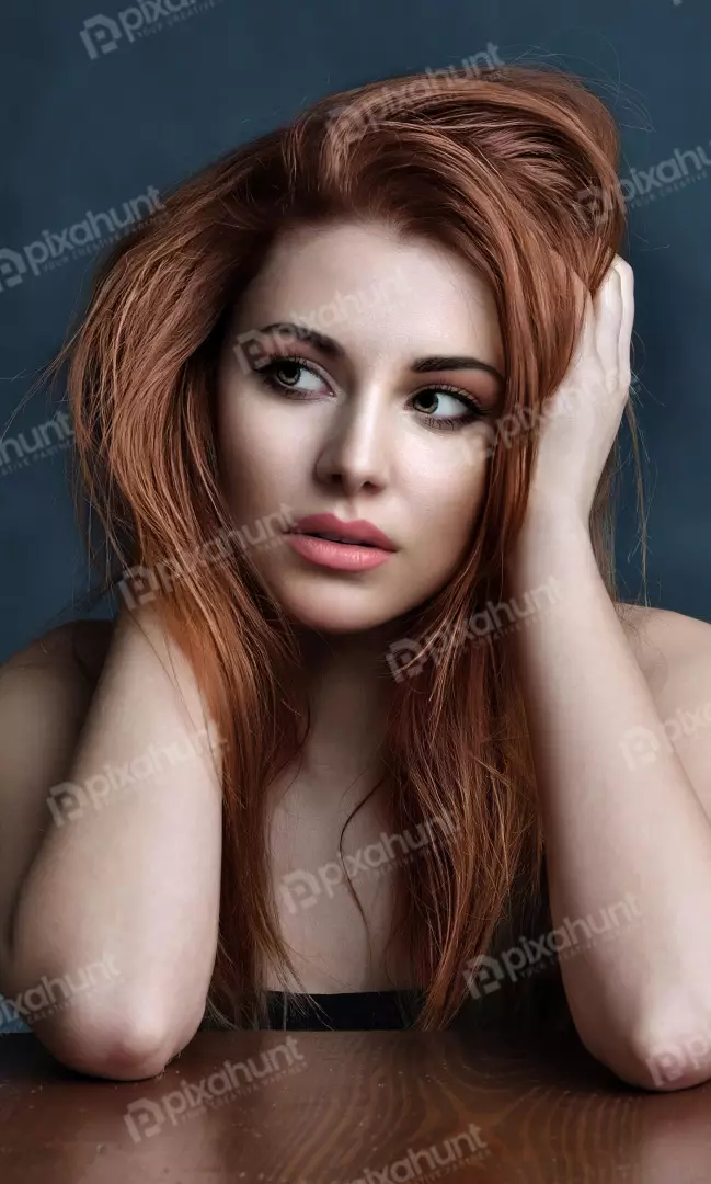 Pensive Young Woman with Red Hair and Captivating Gaze