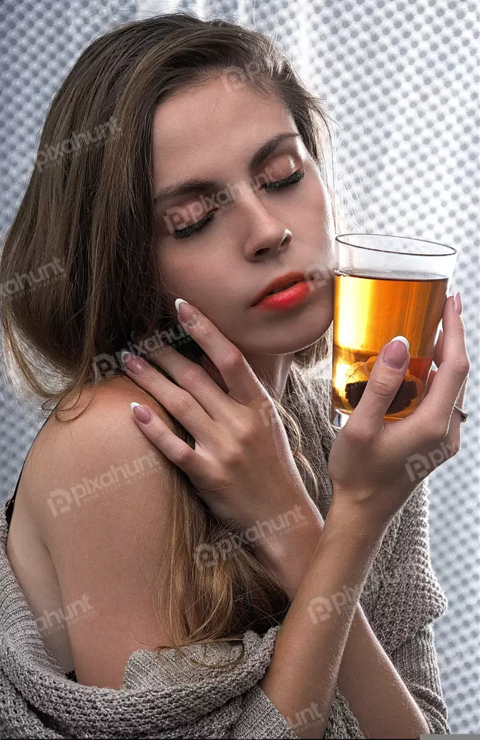 Serene Woman Enjoying a Warm Beverage with Closed Eyes and Delicate Hands