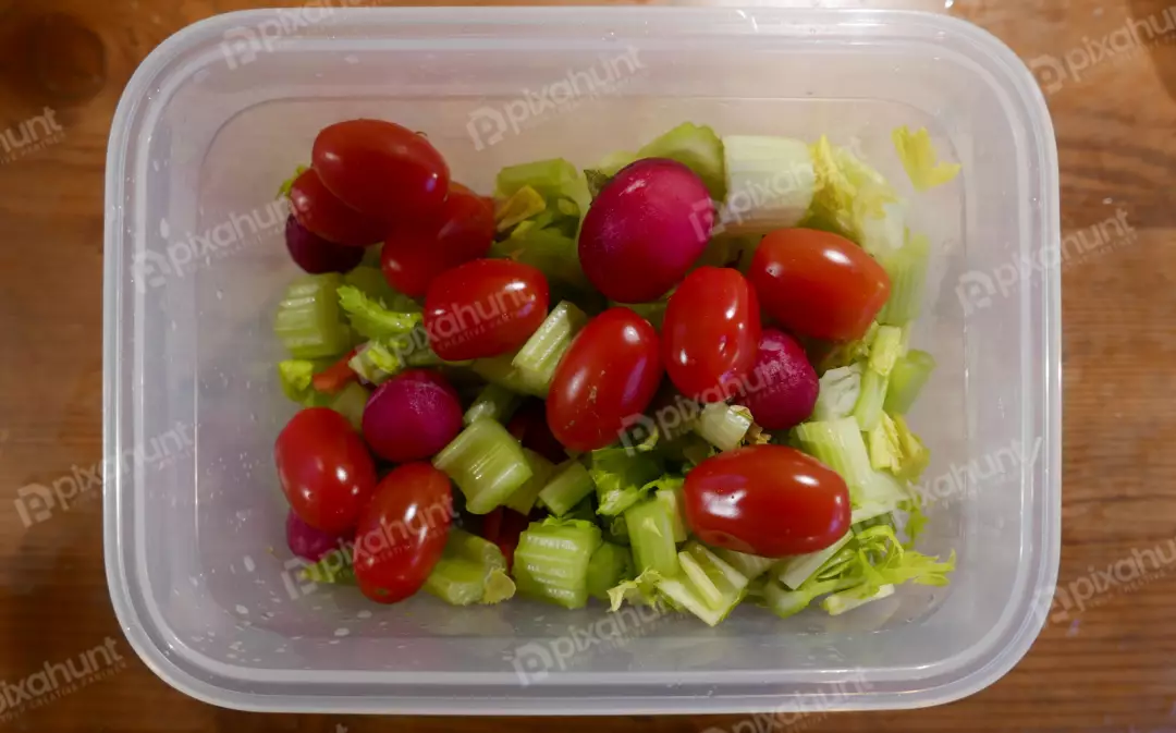 Fresh Vegetable Salad in Plastic Container with Cherry Tomatoes, Celery, Radishes
