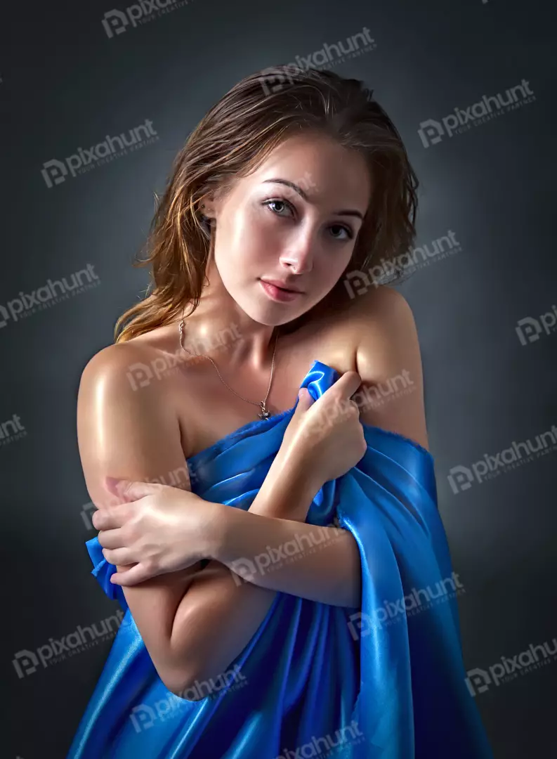 Sensual Young Woman Draped in Blue Silk Fabric Studio Portrait