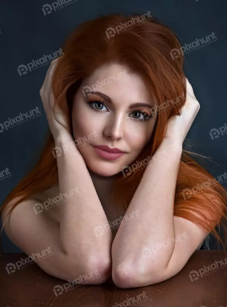 Captivating Redhead Woman with Emerald Eyes Posing with Hands Near Head