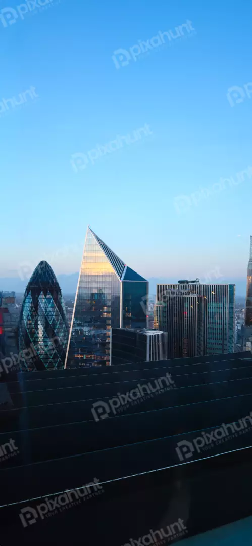 Free Premium Stock Photos London City Skyline at Dusk with Iconic Gherkin and modern skyscrapers