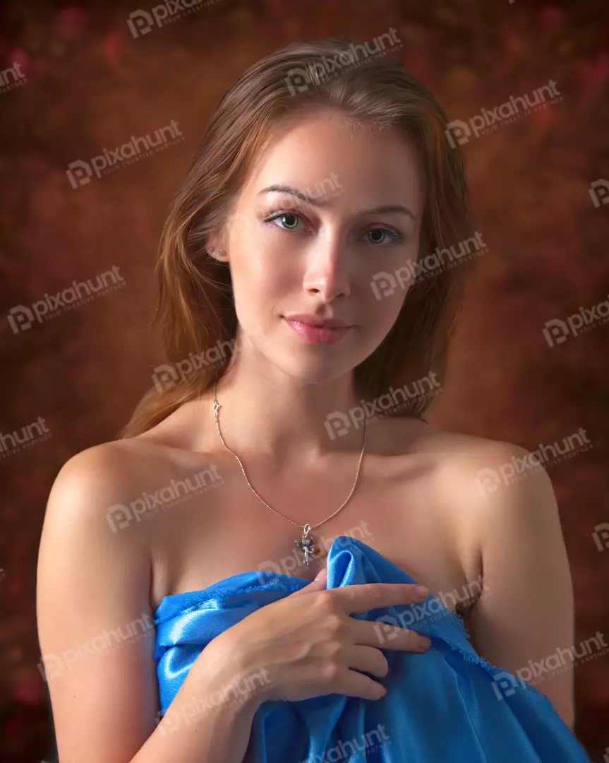 Captivating Young Woman in Blue Silk Draped with Angel Pendant