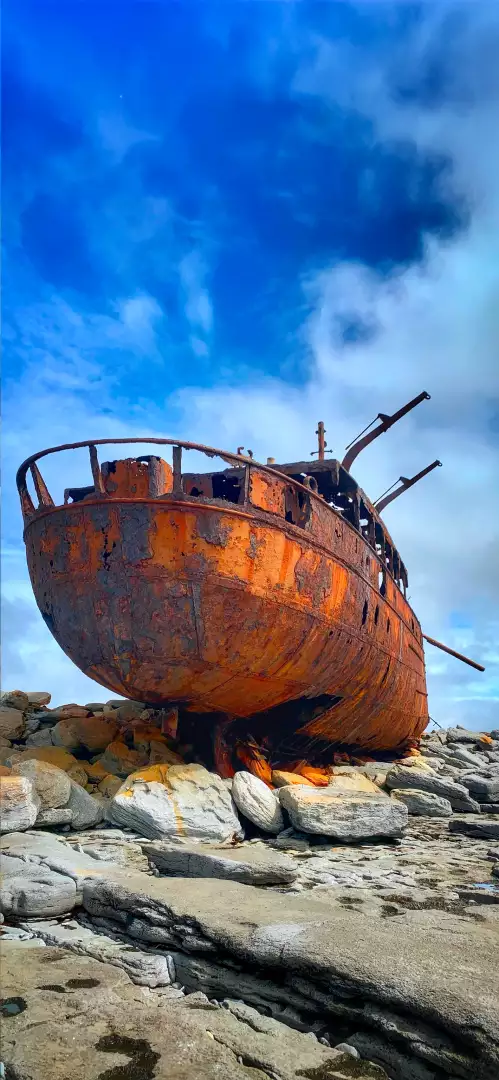 Free Premium Stock Photos Rusted Shipwreck Aground on Rocky Shore Under Dramatic Cloudy Sky