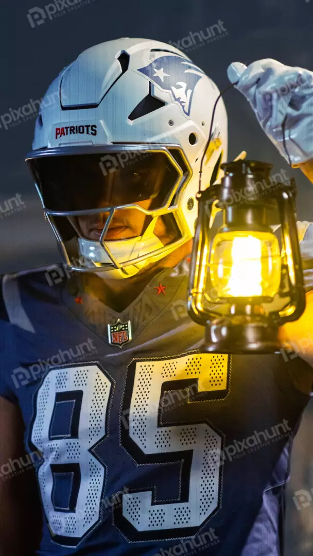 Free Premium Stock Photos New England Patriots Football Player with Helmet Holding Glowing Lantern in Darkness