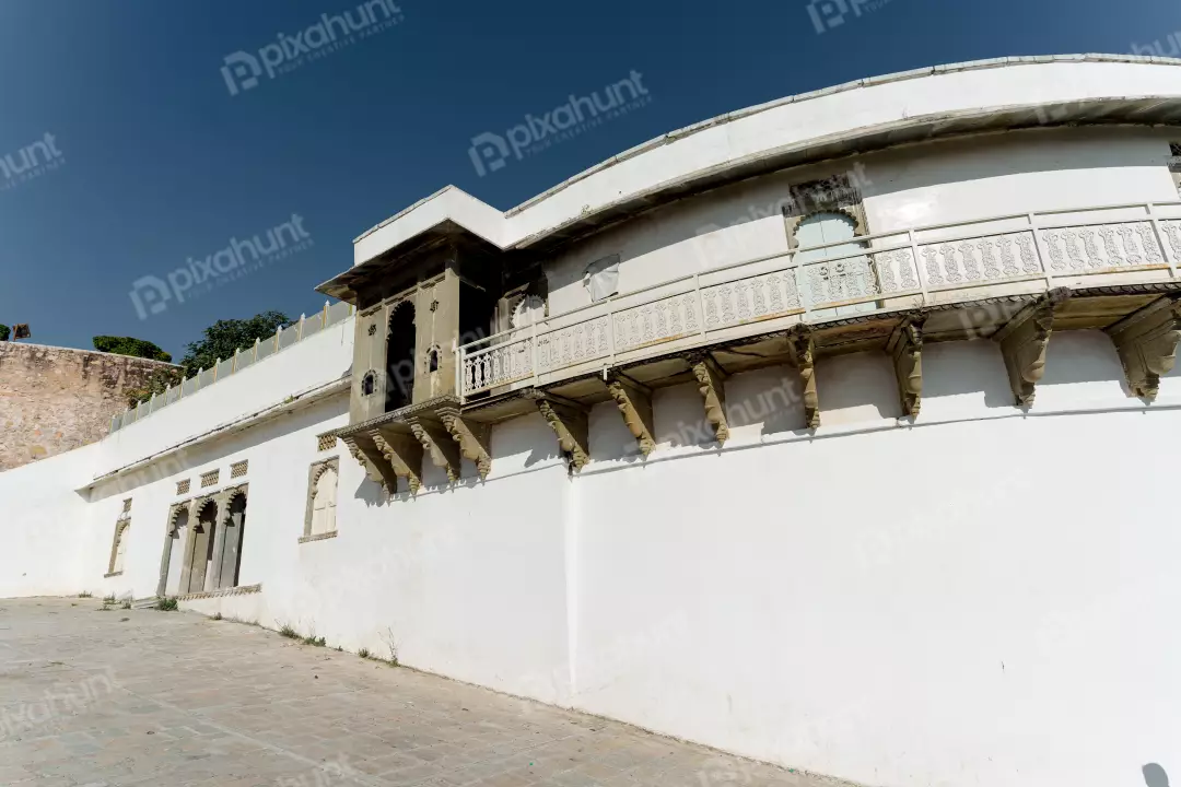 Historic White Palace with Ornate Balconies Under a Clear Blue Sky