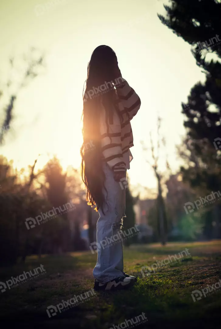 Free Premium Stock Photos Young Woman with Long Hair Backlit by Golden Sunset in a Peaceful Park