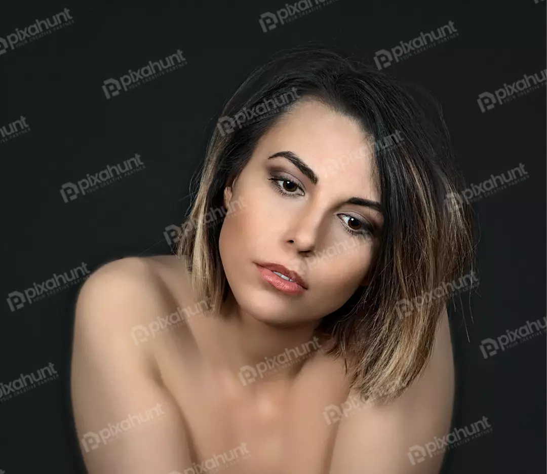 Beautiful Young Woman with Ombre Hair and Thoughtful Gaze Against a Dark Studio Backdrop