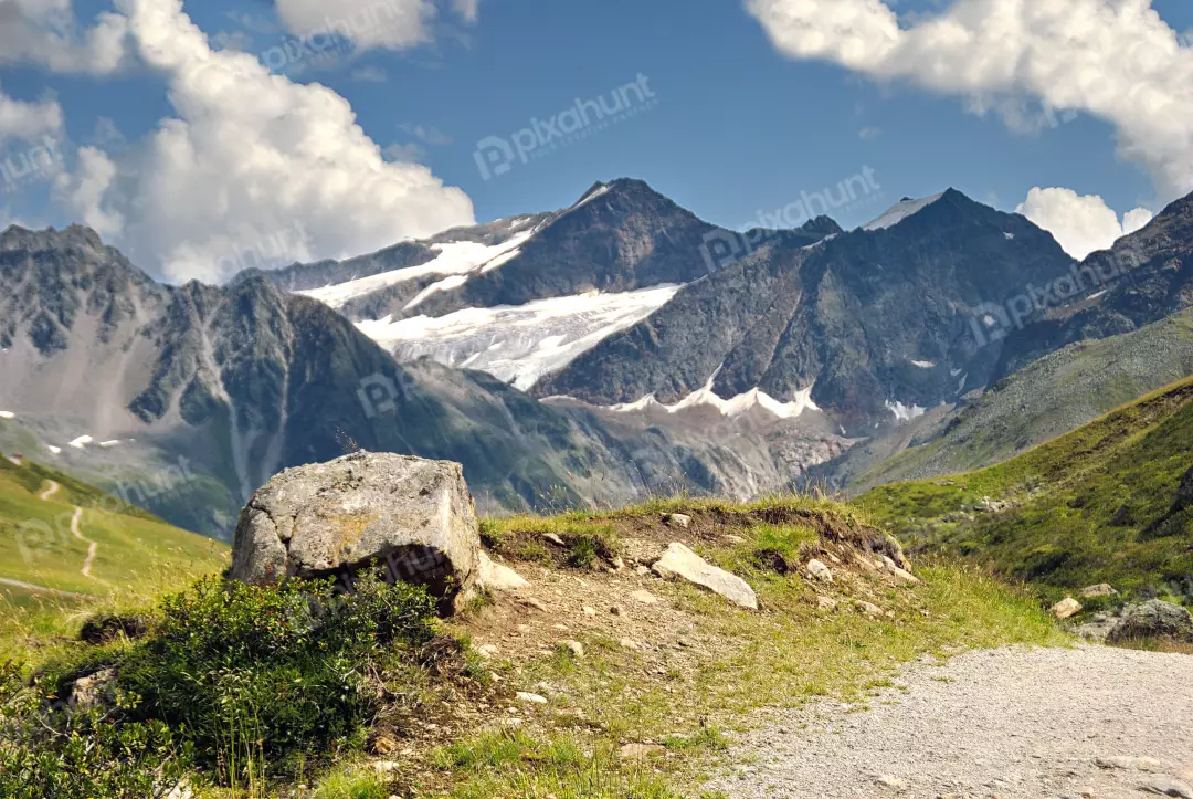 Majestic Alpine Landscape with Glacial Peaks, Green Valleys, and Rocky Terrain