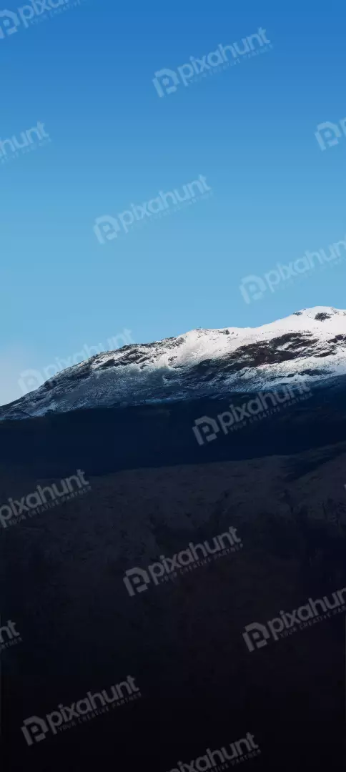 Free Premium Stock Photos Sunlit Snow-Capped Mountain Under Clear Blue Sky