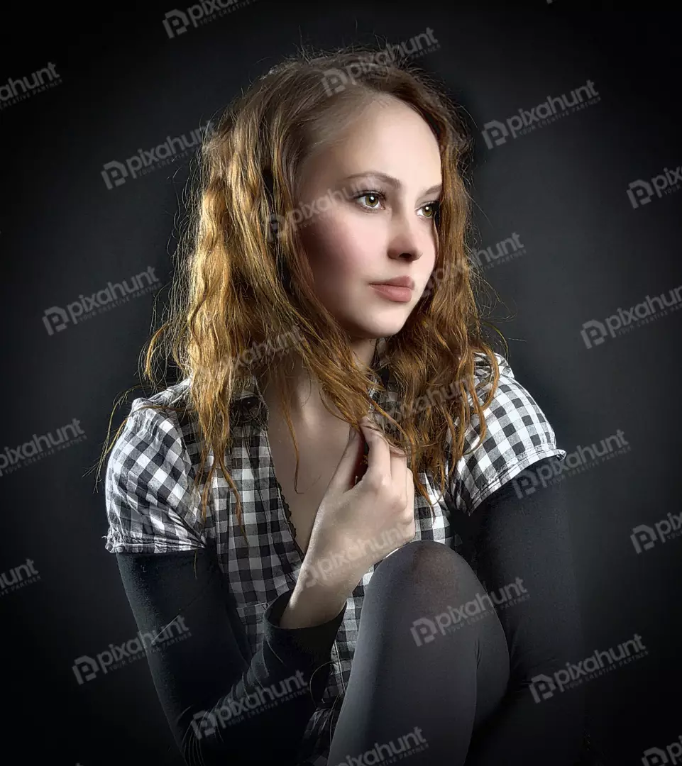 Pensive Young Woman with Wavy Hair in Casual Plaid Shirt Portrait