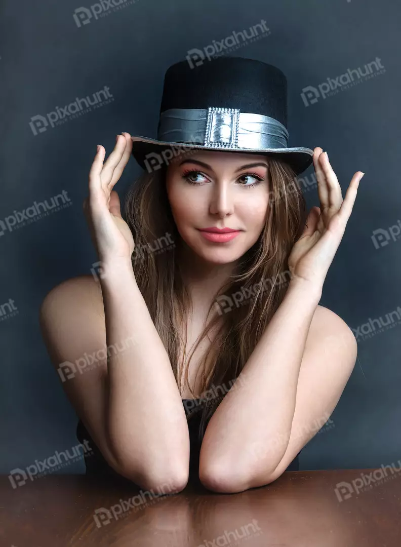 Portrait of Woman Adjusting Black Top Hat with Stylish Silver Buckle