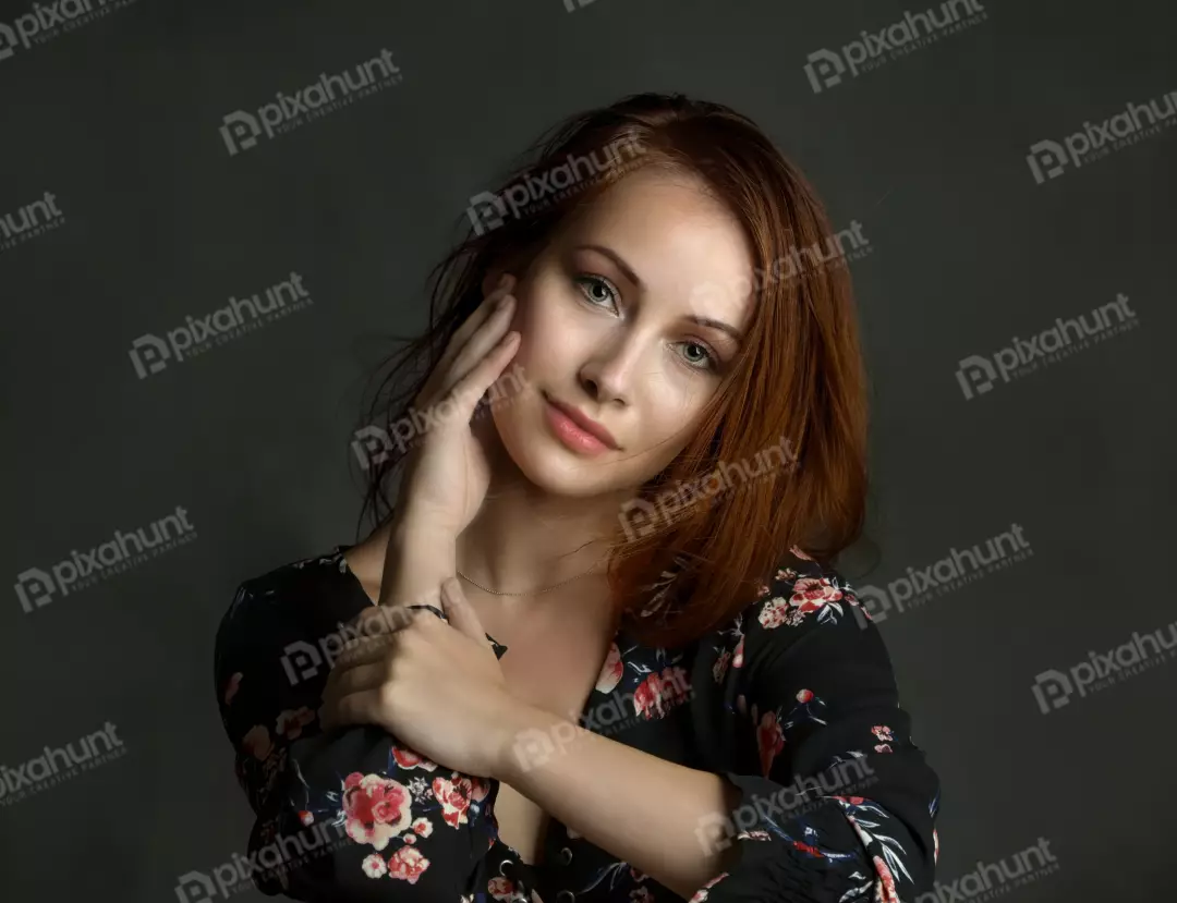 Red-Haired Woman in Floral Top, Pensive Studio Portrait
