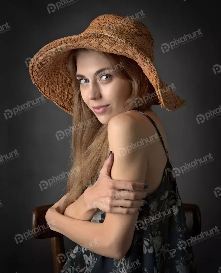 Beautiful Young Woman in Straw Hat Looking Over Shoulder