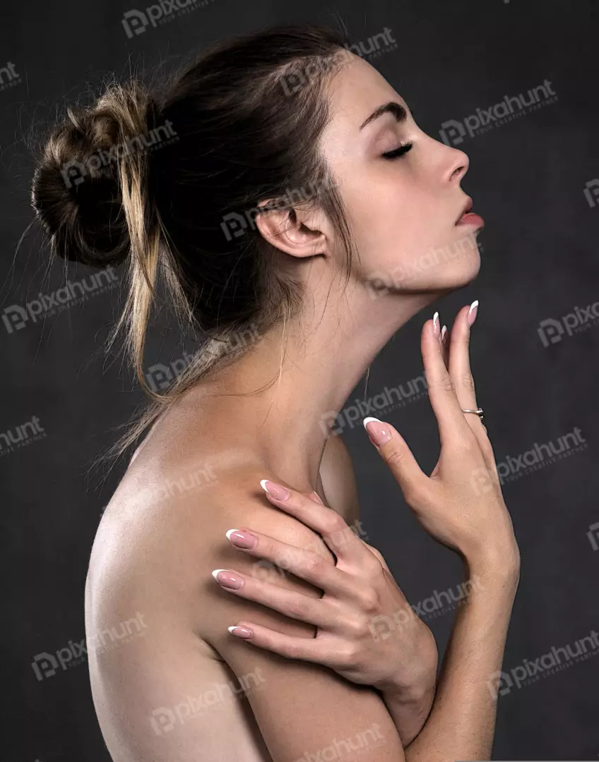 Beautiful Young Woman with Elegant French Manicure Posing Serene