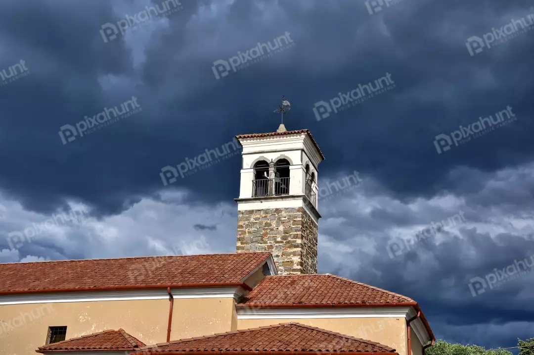 Historic Church Bell Tower Under Dark Dramatic Storm Clouds