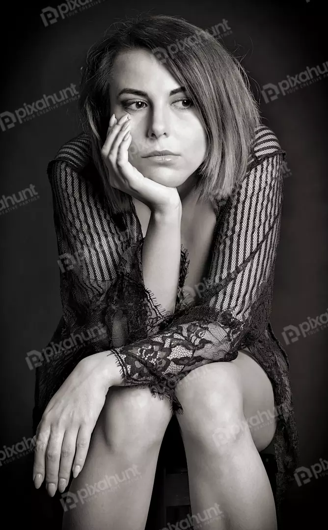 Pensive Woman in Delicate Lace, Striking Black and White Studio Portrait