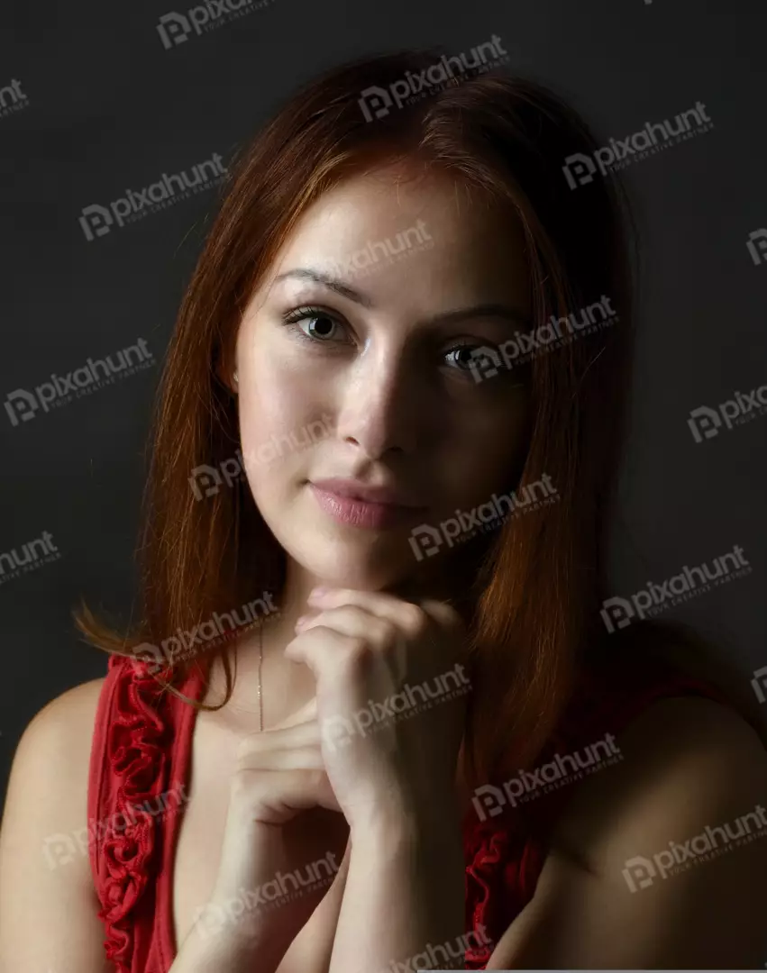 Captivating Redhead Woman with Green Eyes Posing in Red Blouse