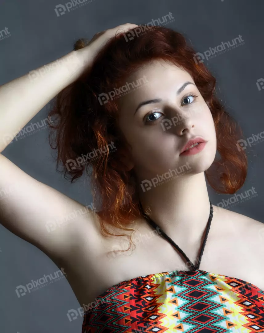 Young Woman with Red Curly Hair Posing in Colorful Ethnic Top
