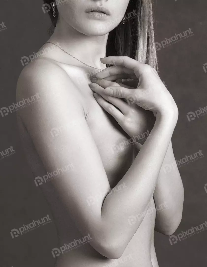 Serene Monochrome Portrait of Woman's Bare Torso with Hands Covering Chest