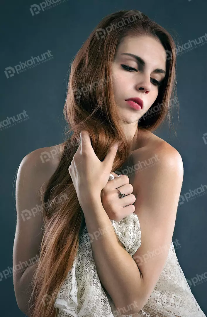 Captivating Portrait of Pensive Woman with Long Reddish Hair and Lace Garment