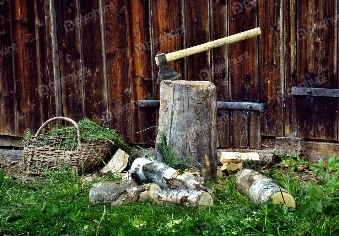 Rustic Axe Embedded in Chopping Block with Wooden Barn Background