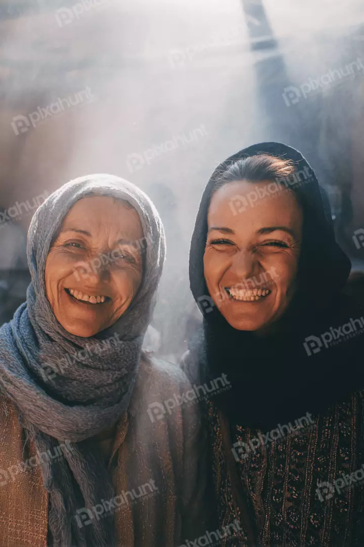 Free Premium Stock Photos Generational Bond: Two Joyful Women in Headscarves Sharing Radiant Smiles