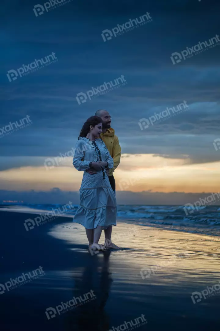Free Premium Stock Photos Couple Embracing on Serene Beach at Sunset